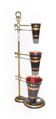 Lot 312 - A set of three graduated toleware flower pots on adjustable rise and fall stand, 57cm