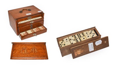 Lot 314 - An oak cased Chinese mahjong set and a box of ebony and bone dominoes