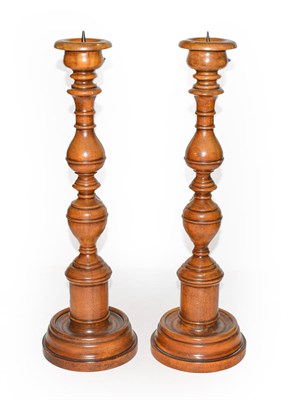 Lot 325 - A pair of Theodore Alexander modern turned wooden pricket sticks, 43cm high