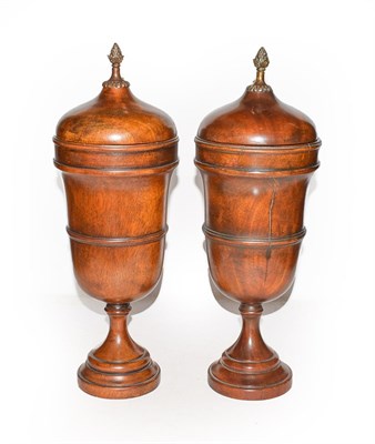 Lot 326 - Theodore Alexander, a pair of modern turned hardwood urns and covers with patinated metal...