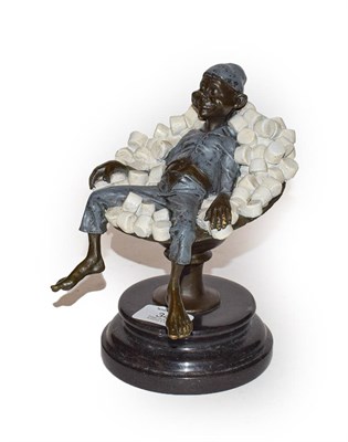 Lot 342 - A cold painted bronze figure of an elf reclining asleep in a stemmed bowl of white...