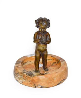 Lot 348 - Early 20th century bronze of a child with sponge on an onyx dish base, 18cm diameter, 20cm high