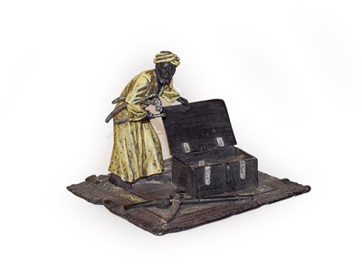 Lot 359 - A cold painted bronze figure of a carpet seller, 13cm wide