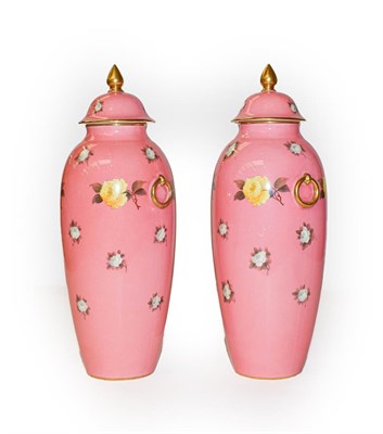 Lot 360 - A pair of cauldron floral vases and covers on a pink ground, 25cm