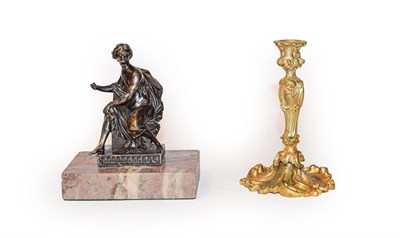 Lot 377 - A gilt bronze taperstick and a cast brass figure on marble base