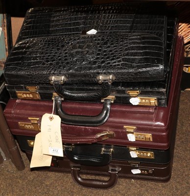 Lot 412 - A black document bag, four briefcases, in black and brown