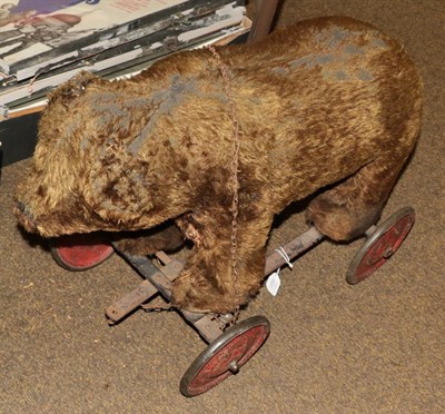 Lot 419 - A child's mid-20th century toy push along plush bear