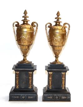 Lot 435 - A pair of 19th century gilt metal urns decorated with Classical figures on stepped slate bases,...