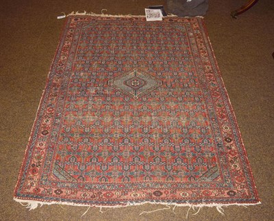 Lot 1146 - A Hamadan rug, the madder lattice field with central diamond medallion enclosed by triple...