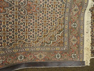 Lot 1150 - A good narrow Tabriz runner, the ivory Herati field with three medallions enclosed by samovar motif