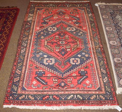 Lot 1156 - A Hamadan rug, the tomato red field with serrated medallion framed by leaf and calyx borders, 206cm