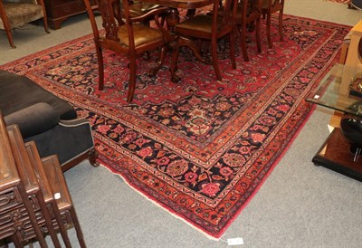 Lot 1162 - A North West Persian carpet, the raspberry field with a central medallion and trailing plants...