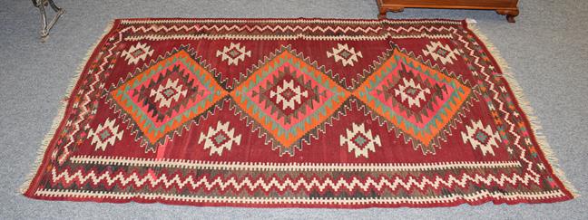 Lot 1163 - A Kilim rug polychrome with three central lozenges, 240cm by 145cm