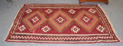 Lot 1163A - A Kilim rug polychrome with three central lozenges, 240cm by 145cm