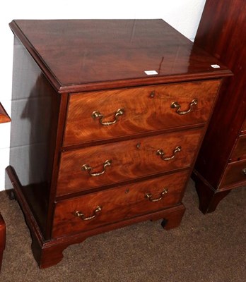 Lot 1167 - A George III figured mahogany three-height chest of small proportions with oak drawer lining...