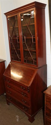 Lot 1171 - An Edwardian mahogany bureau bookcase, with astragal glazed top section, cross banded in satinwood
