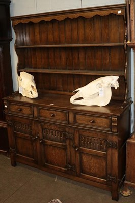 Lot 1176 - A 20th century priory style carved oak dresser and rack, 137cm by 42cm by 117cm
