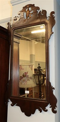 Lot 1182 - A mahogany and parcel gilt fret mirror with eagle form pediment, 106cm by 54cm together with a...
