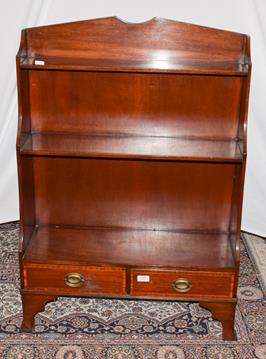 Lot 1184 - An early 20th century mahogany waterfall bookcase, cross banded incorporating two-drawers and...
