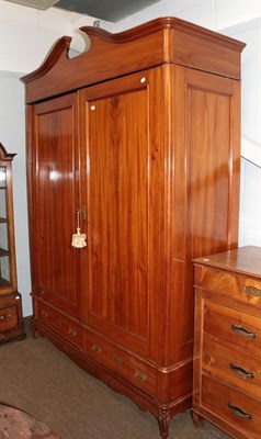 Lot 1186 - A large 20th century Continental walnut double wardrobe with arched pediment and two-drawer...