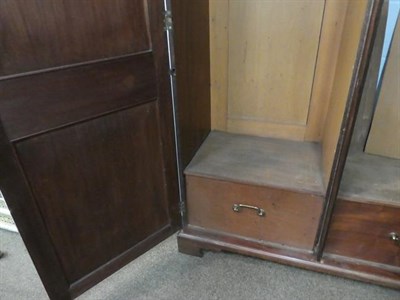 Lot 1188 - A Victorian figured mahogany double wardrobe with panelled doors, raised on bracket feet, 129cm...
