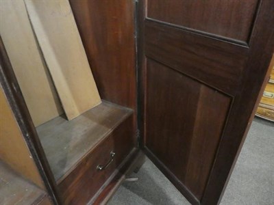 Lot 1188 - A Victorian figured mahogany double wardrobe with panelled doors, raised on bracket feet, 129cm...