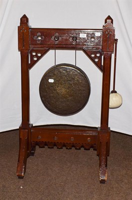 Lot 1198 - A Gothic revival dinner gong with beater, 100cm high