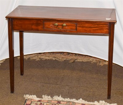 Lot 1209 - A Georgian mahogany single-drawer side table, raised on reeded square tapering supports, 90cm...