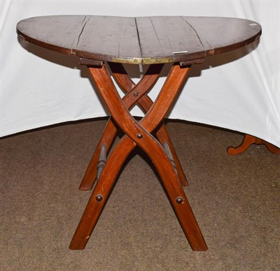 Lot 1213 - A Victorian pine coaching table of circular shape, folding on scissor supports, 80cm diameter