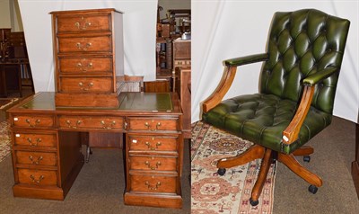 Lot 1218 - A mahogany twin-pedestal leather topped desk, 138cm by 77cm by 76cm together with a matching filing