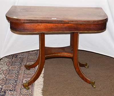 Lot 1224 - A 19th century rosewood fold-over card table with gilt metal mounts, 92cm by 45cm by 73cm (a.f.)