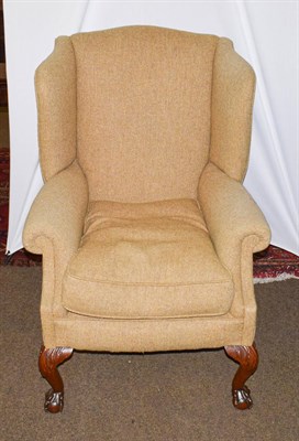 Lot 1234 - A mahogany framed wing back chair on ball and claw feet