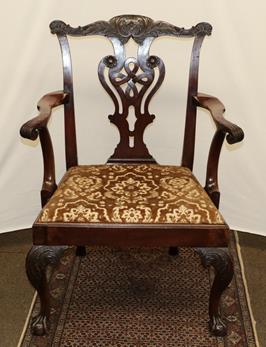 Lot 1245 - A George III mahogany armchair with carved cresting rail, openwork baluster splat and raised on...