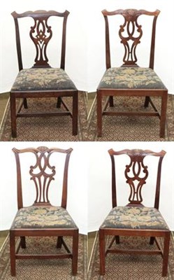 Lot 1247 - An assembled set of four Georgian carved mahogany dining chairs (4)