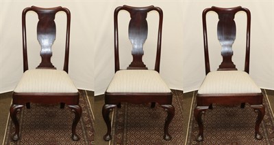 Lot 1248 - Three George II style carved mahogany dining chairs (3)