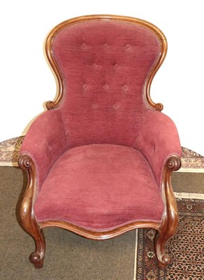 Lot 1250 - A Victorian carved mahogany spoon backed nursing chair on carved scroll supports