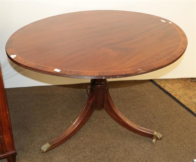 Lot 1254 - A 19th century mahogany breakfast table crossbanded in Rosewood, raised on a reeded tripod with...