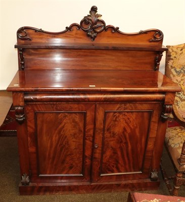 Lot 1259 - An early Victorian mahogany chiffonier, shelved superstructure with scroll pediment, the front with