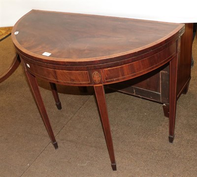 Lot 1263 - A George III cross-banded mahogany fold over demi-lune tea table, 91cm by 45cm by 73cm