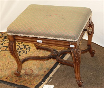 Lot 1277 - A late Victorian walnut framed adjustable piano stool, with rectangular stuffed cushion, on...