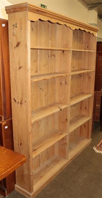 Lot 1291 - A pine double-open bookcase with reeded mouldings, 150cm by 23cm by 184cm