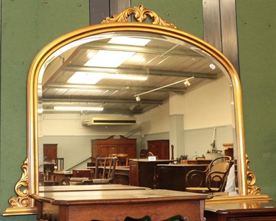 Lot 1305 - A large gilt framed arched top over mantel mirror, 144cm by 102cm