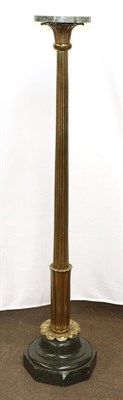 Lot 1308 - A marble and gilt metal torchere, the circular top above a reeded standard raised on an...