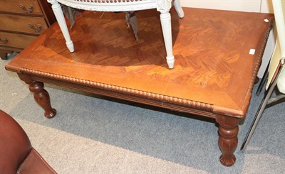 Lot 1319 - A modern oak parquet top coffee table with bobbin turned mouldings and baluster supports, 127cm...