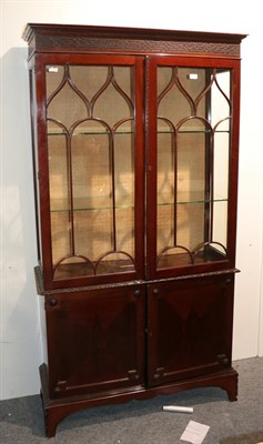 Lot 1325 - A Chippendale style glazed mahogany bookcase decorated with blind fretwork, 106cm by 38cm by 196cm