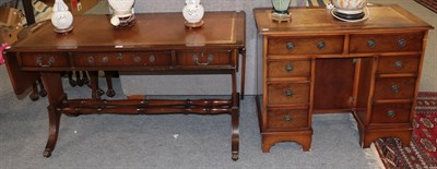 Lot 1336 - A Regency style mahogany sofa table with leather inset top, reeded supports and brass paw...