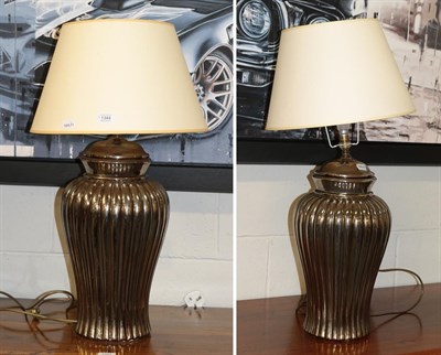 Lot 1344 - A pair of large silvered baluster form table lamps, 72cm including shade