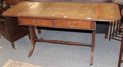 Lot 1370 - An early 20th century mahogany leather topped two drawer sofa table with reeded sabre supports...