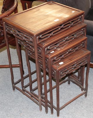 Lot 1372 - A nest of four 19th century Chinese hardwood occasional table, each with open work scrolling frieze