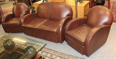 Lot 1384 - A modern Art Deco style brown leather three piece suite comprising two seater settee and a pair...